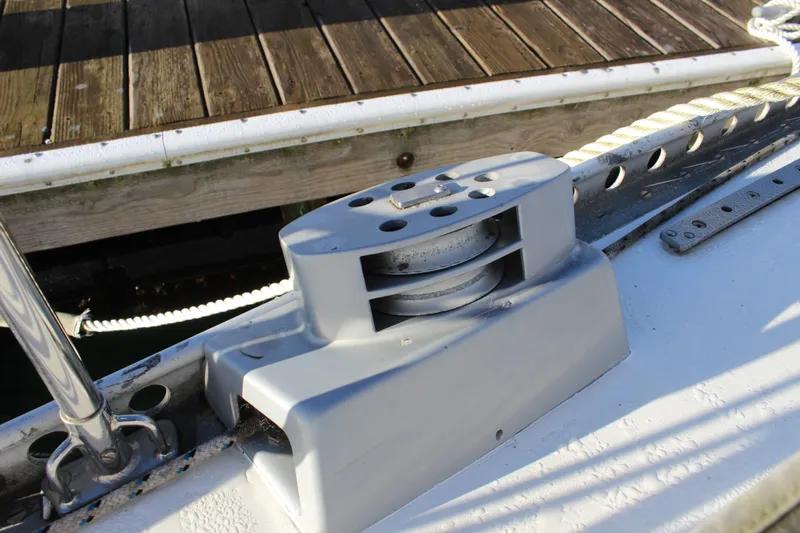Slide: The Image of Deck detail of a 1973 Nautor Swan 44 sailboat, featuring a winch and cleat. - 25