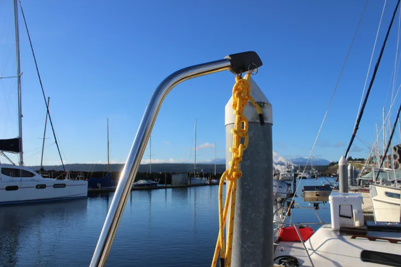 Slide: The Image of Sailboat docked at marina, featuring Nautor Swan 44, 1973 model, with clear blue sky. - 27
