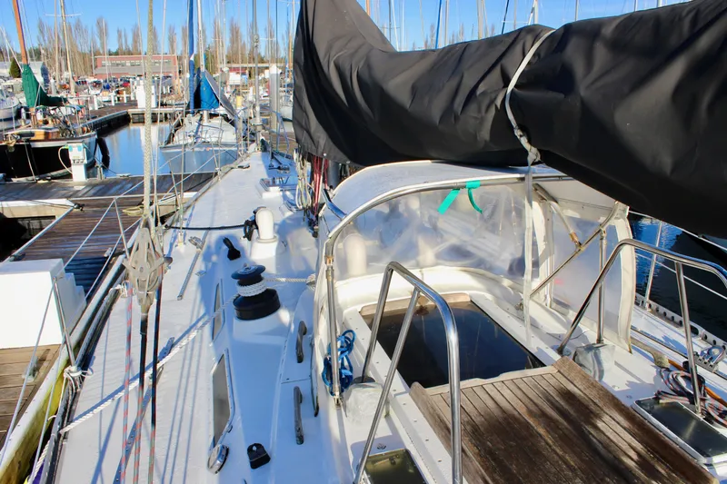 Slide: The Image of 1973 Nautor Swan 44 sailboat docked at marina, featuring deck and cockpit view. - 31