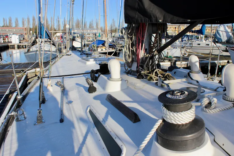 Slide: The Image of Deck view of a 1973 Nautor Swan 44 sailboat docked at a marina. - 32