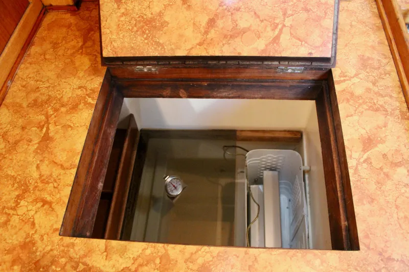 Slide: The Image of Open hatch on 1973 Nautor Swan 44 yacht, revealing storage compartment. - 39
