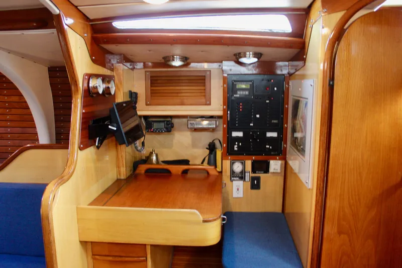 Slide: The Image of Interior of 1973 Nautor Swan 44 sailboat with navigation station and wooden finish. - 41