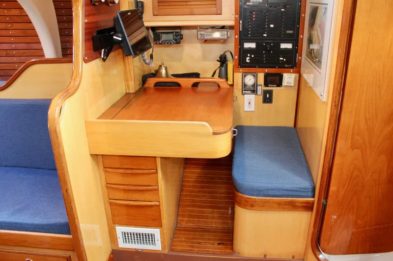 Slide: The Image of Interior of 1973 Nautor Swan 44 yacht with navigation station and wooden cabinetry. - 42