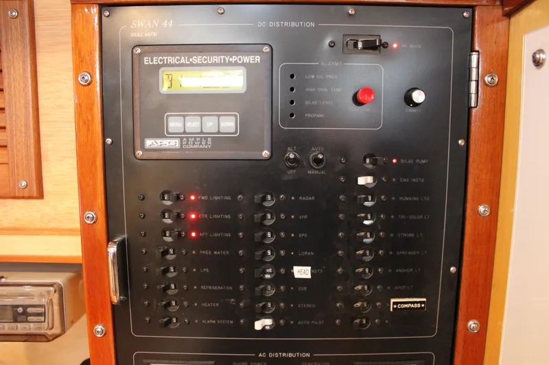 Slide: The Image of Electrical control panel of a 1973 Nautor Swan 44 yacht, featuring various switches and indicators. - 43