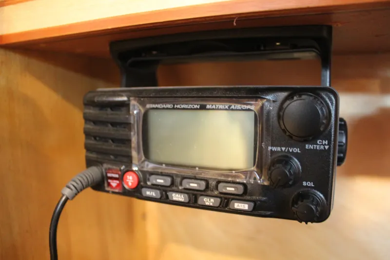 Slide: The Image of Standard Horizon marine radio on 1973 Nautor Swan 44 yacht, mounted under wooden shelf. - 46