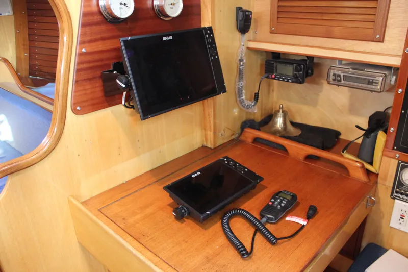 Slide: The Image of Navigation station on a 1973 Nautor Swan 44 yacht with modern equipment and wood finish. - 47
