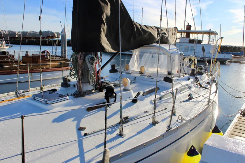 Slide: The Image of 1973 Nautor Swan 44 sailboat docked in a sunny marina. - 5