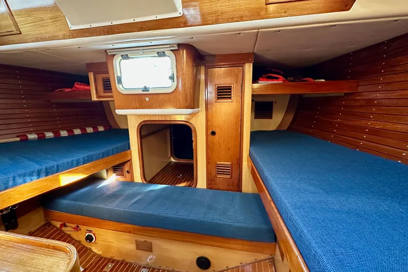 Slide: The Image of Interior of 1973 Nautor Swan 44 yacht with wooden finish and blue cushions. - 52
