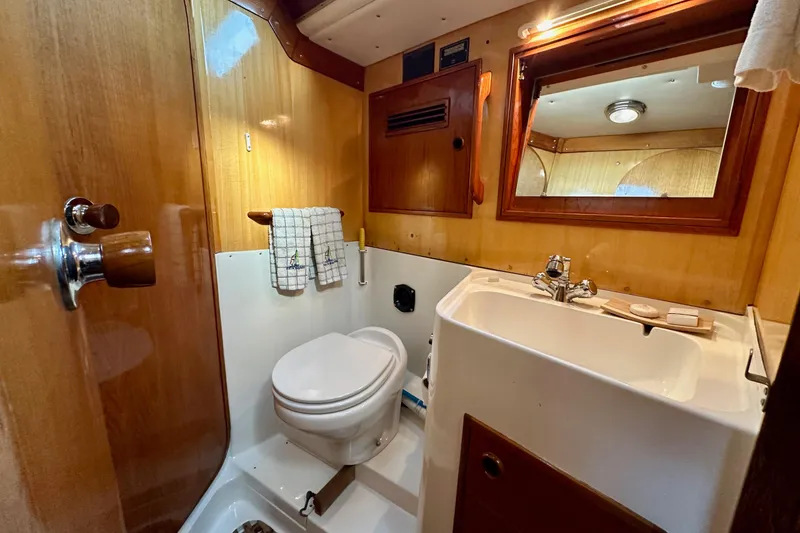 Slide: The Image of Interior of 1973 Nautor Swan 44 yacht bathroom with wooden accents and mirror. - 62