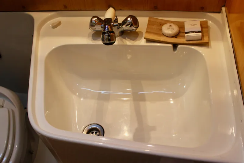 Slide: The Image of Bathroom sink with soap and faucet on a 1973 Nautor Swan 44 yacht. - 64