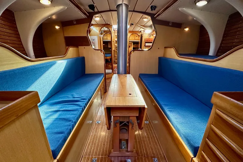 Slide: The Image of Interior of 1973 Nautor Swan 44 yacht with blue seating and wooden finishes. - 69