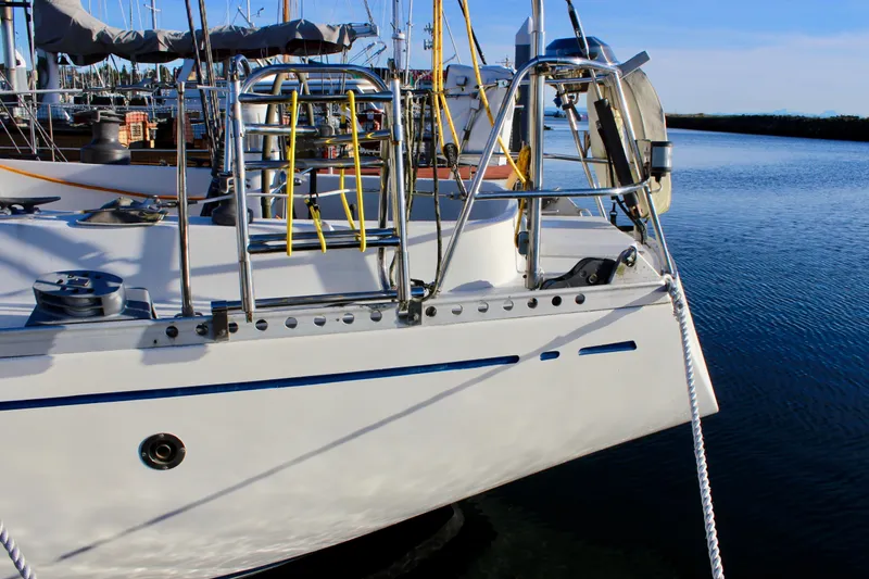 Slide: The Image of 1973 Nautor Swan 44 sailboat docked, featuring sleek design and polished metal railings. - 7