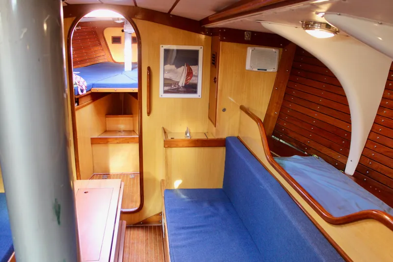 Slide: The Image of Interior of 1973 Nautor Swan 44 yacht with wooden paneling and blue seating. - 71