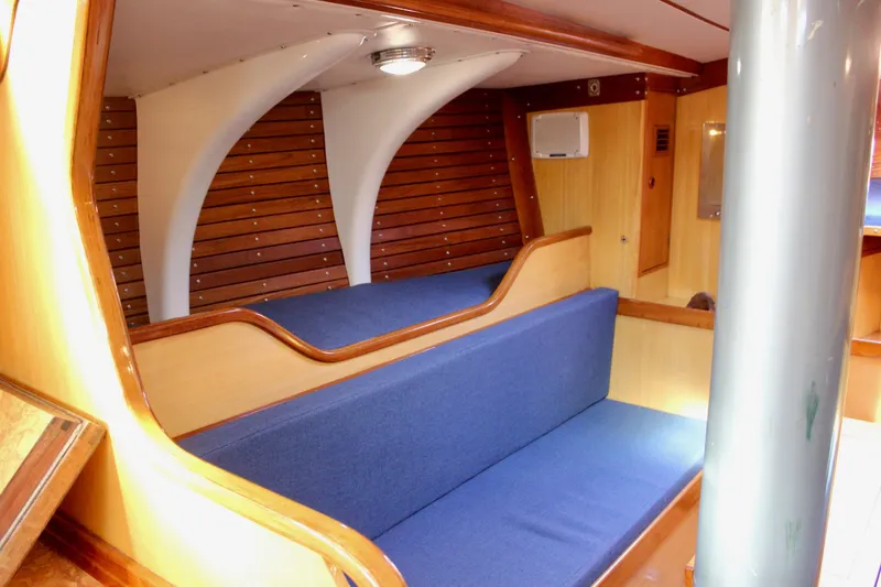 Slide: The Image of Interior of 1973 Nautor Swan 44 yacht with blue seating and wooden accents. - 72