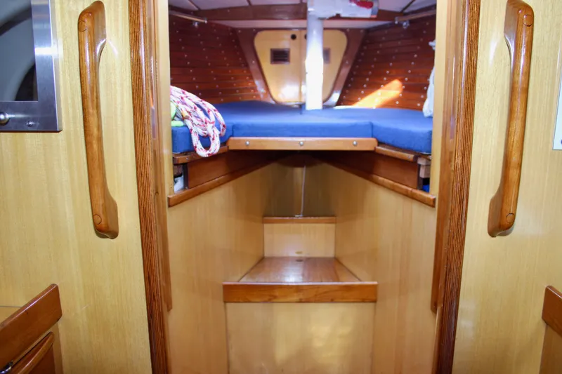 Slide: The Image of Interior of 1973 Nautor Swan 44 sailboat with wooden finish and blue bedding. - 75