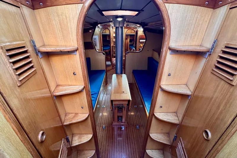 Slide: The Image of Interior of 1973 Nautor Swan 44 sailboat with wooden finish and blue seating. - 79