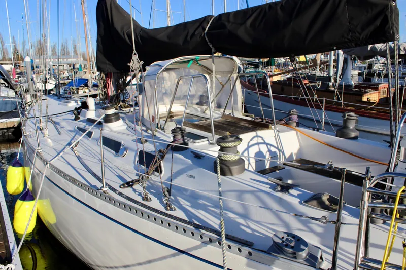 Slide: The Image of 1973 Nautor Swan 44 sailboat docked at marina, featuring sleek design and rigging. - 8