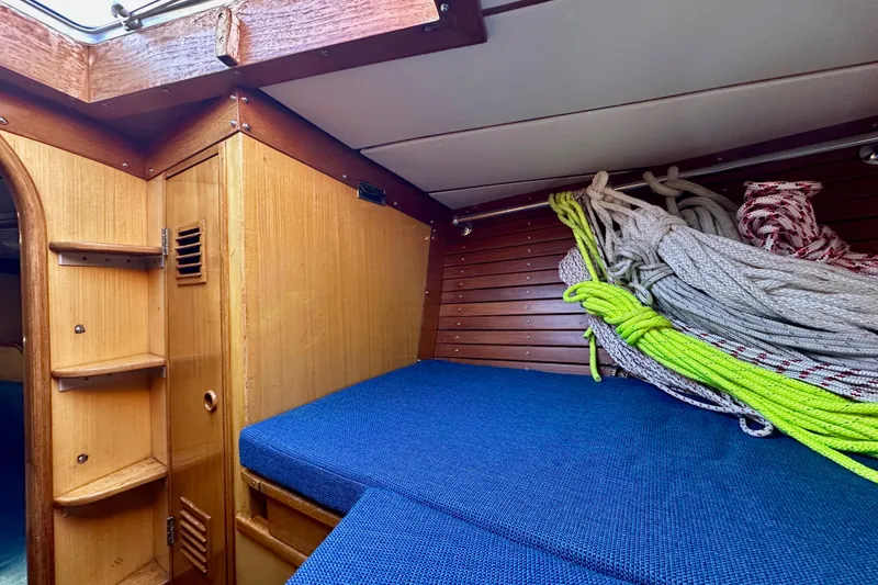 Slide: The Image of Interior of 1973 Nautor Swan 44 sailboat with ropes and blue cushions. - 80