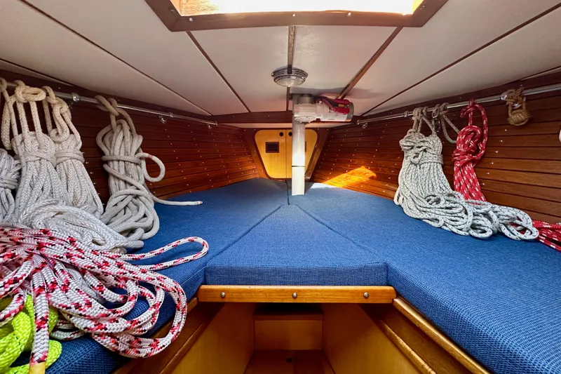Slide: The Image of Interior of 1973 Nautor Swan 44 sailboat with ropes and blue cushions. - 81