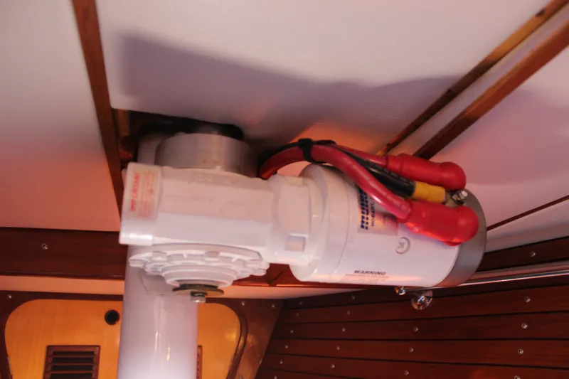 Slide: The Image of Electrical component inside a 1973 Nautor Swan 44 yacht, featuring red and black cables. - 82