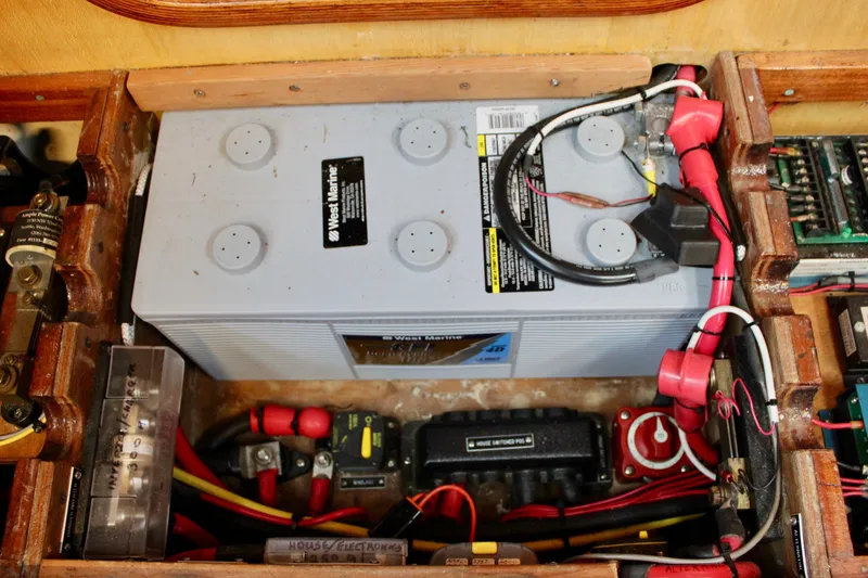 Slide: The Image of Battery compartment of a 1973 Nautor Swan 44 sailboat with wiring and connections. - 86