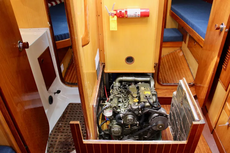 Slide: The Image of Engine room of a 1973 Nautor Swan 44 sailboat with visible engine and fire extinguisher. - 91