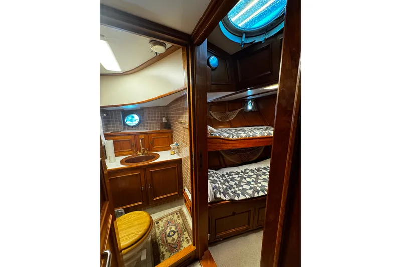 Slide: The Image of Cozy 1974 Doggersbank 63 yacht interior with wooden cabinetry and bunk beds. - 10