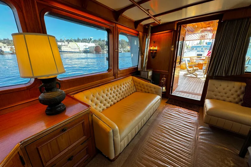 Slide: The Image of Luxurious 1974 Doggersbank 63 yacht interior with leather seating and waterfront view. - 2