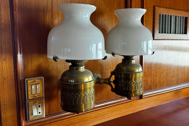 Slide: The Image of Vintage brass wall lamps with white glass shades on wooden paneling, Doggersbank 63, 1974. - 25