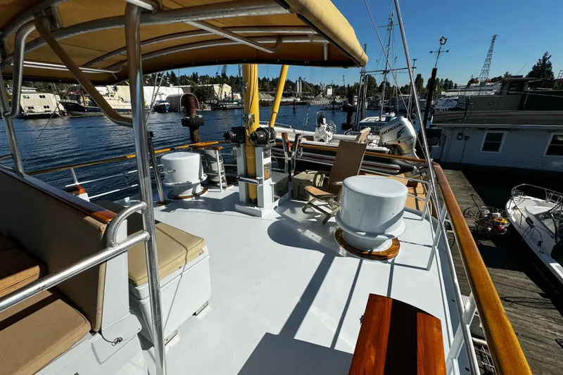 Slide: The Image of 1974 Doggersbank 63 yacht deck with seating and marina view. - 26