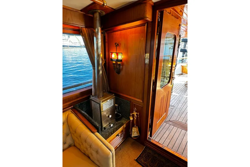 Slide: The Image of Cozy interior of 1974 Doggersbank 63 yacht with wood stove and elegant decor. - 3