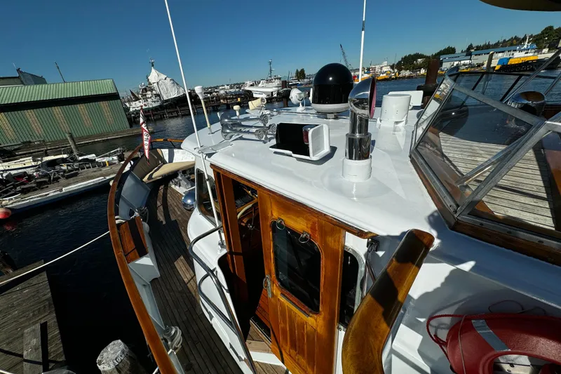 Slide: The Image of 1974 Doggersbank 63 yacht docked at marina, showcasing wooden deck and nautical equipment. - 30