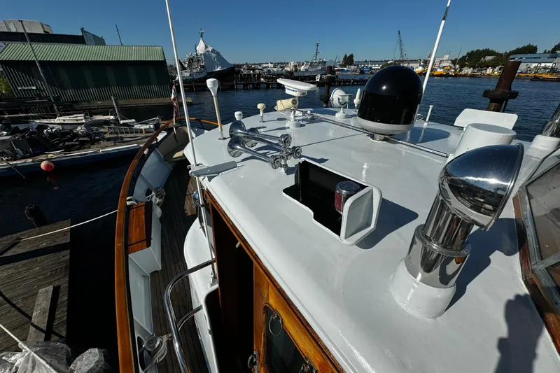 Slide: The Image of 1974 Doggersbank 63 yacht docked at a marina, showcasing its deck and equipment. - 33