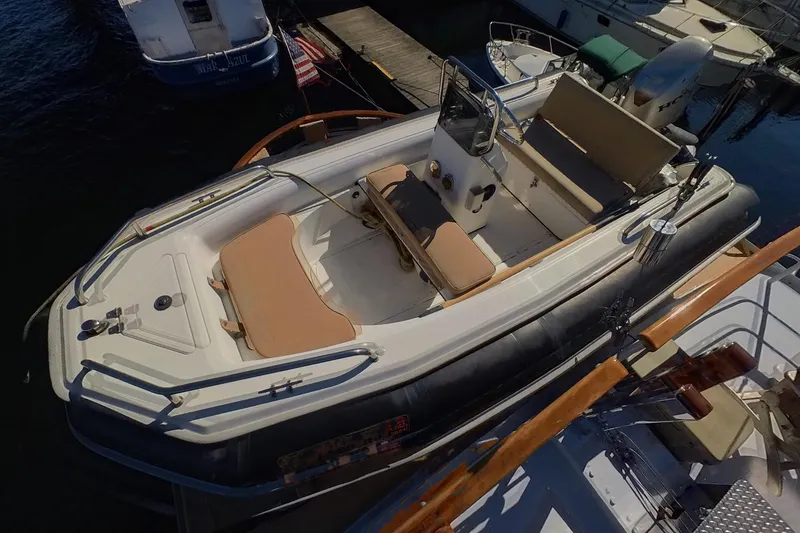 Slide: The Image of 1974 Doggersbank 63 boat docked, featuring beige seating and steering console. - 42