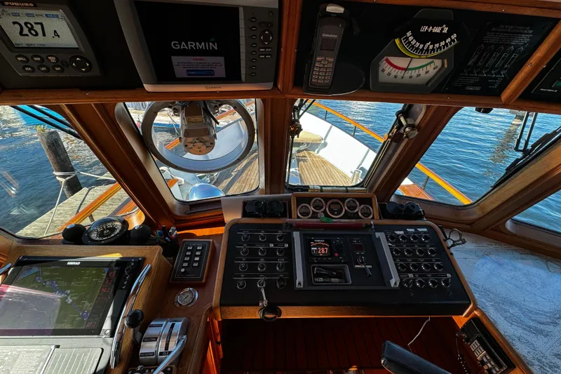 Slide: The Image of Cockpit view of a 1974 Doggersbank 63 yacht with navigation instruments and controls. - 5