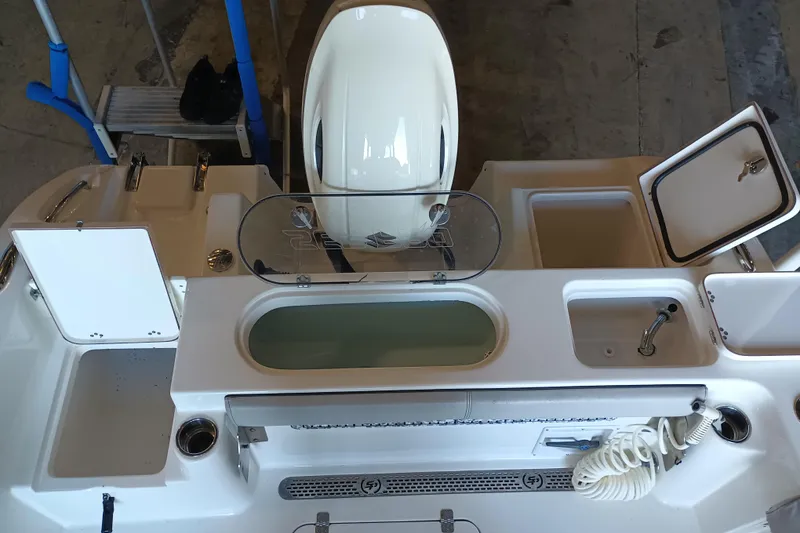 Slide: The Image of 2017 Seapro 219 boat interior with storage compartments and motor, viewed from above. - 20