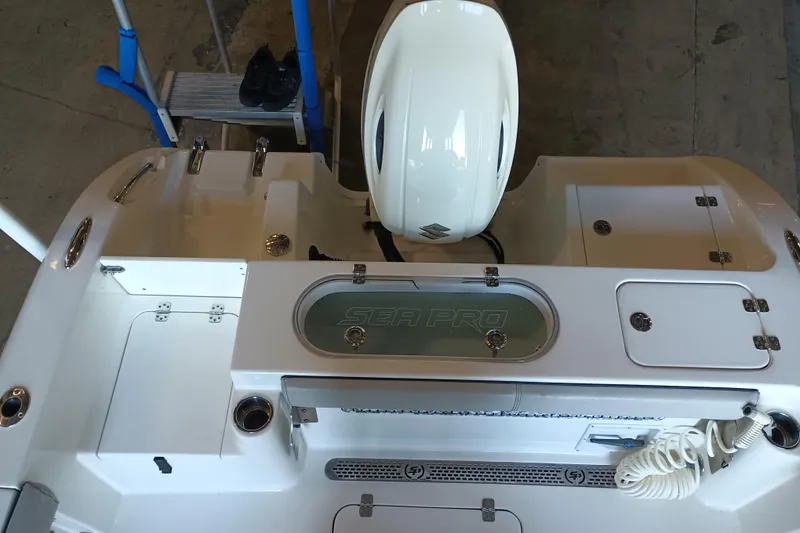 Slide: The Image of 2017 Seapro 219 boat with Suzuki engine, featuring a clean deck and storage compartments. - 21