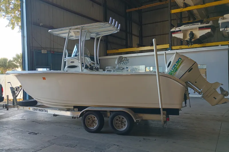 Slide: The Image of 2017 Seapro 219 boat on trailer in storage facility with Suzuki outboard motor. - 3