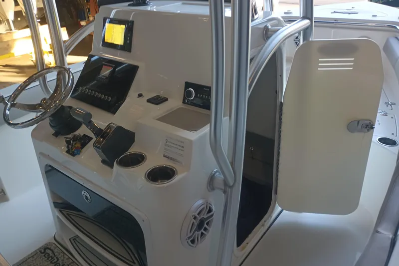 Slide: The Image of 2017 Seapro 219 boat cockpit with steering wheel, controls, and open cabin door. - 8