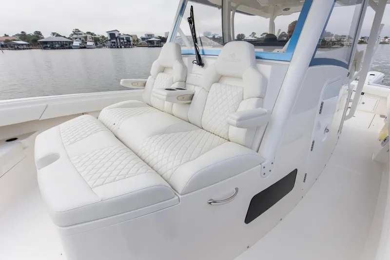 Slide: The Image of Luxurious seating on 2024 Regulator 37 boat, featuring white quilted upholstery. - 10