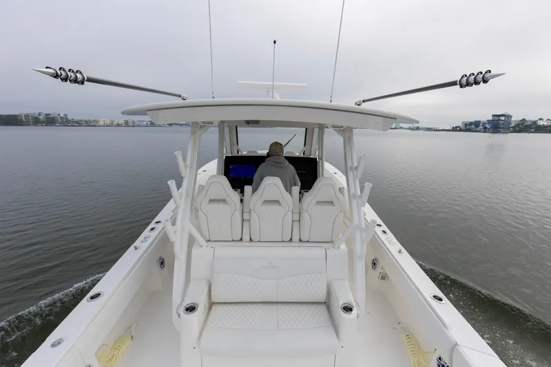 Slide: The Image of 2024 Regulator 37 boat cruising on calm waters, showcasing spacious deck and modern design. - 13