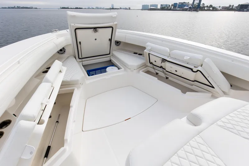 Slide: The Image of 2024 Regulator 37 boat interior with white seating and storage compartments. - 14