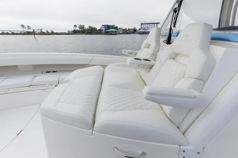 Slide: The Image of Luxurious seating on 2024 Regulator 37 boat with scenic waterfront view. - 15