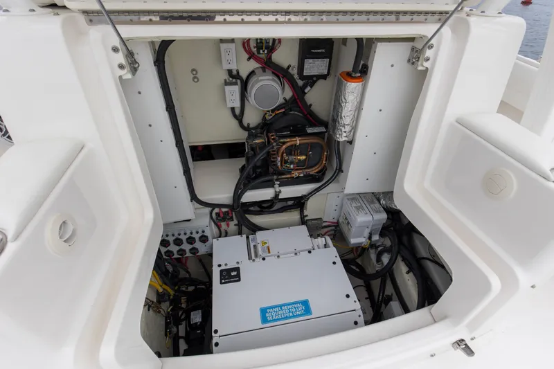 Slide: The Image of 2024 Regulator 37 boat engine compartment with electrical components and wiring. - 17