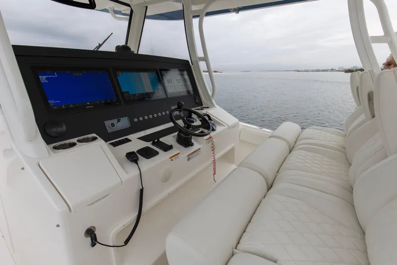 Slide: The Image of 2024 Regulator 37 boat cockpit with advanced navigation displays and luxurious seating. - 18