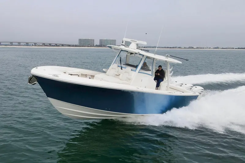 Slide: The Image of 2024 Regulator 37 boat cruising on open water, showcasing sleek design and powerful performance. - 2