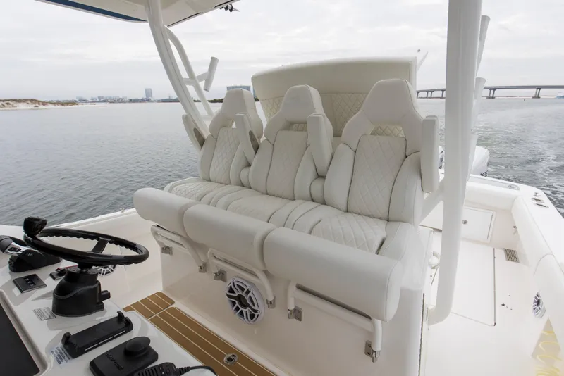 Slide: The Image of 2024 Regulator 37 boat interior with luxurious white seating and modern helm controls. - 23