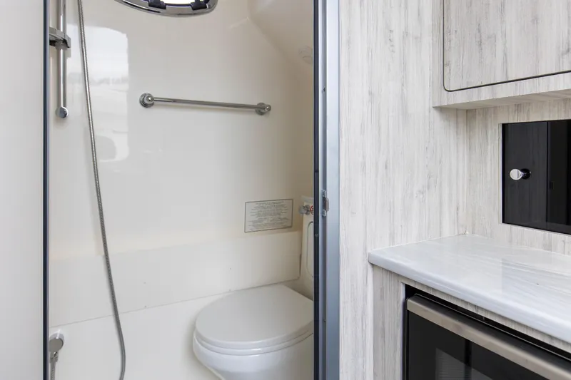 Slide: The Image of 2024 Regulator 37 boat interior bathroom with modern fixtures and wood accents. - 27