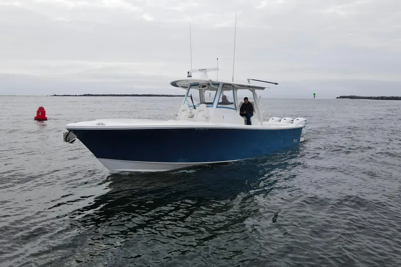 Slide: The Image of 2024 Regulator 37 boat on open water, featuring a sleek blue hull design. - 31