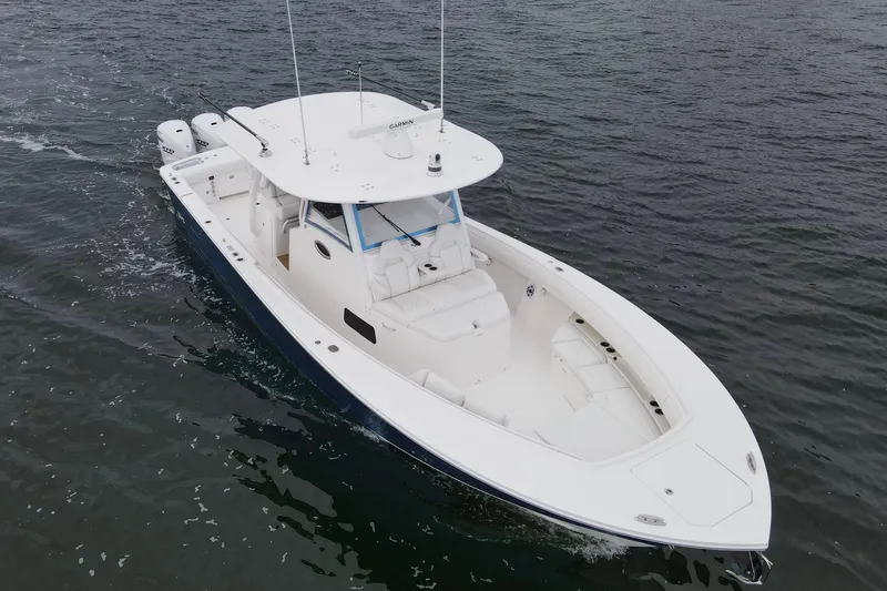 Slide: The Image of 2024 Regulator 37 boat cruising on open water, showcasing sleek design and powerful engines. - 32